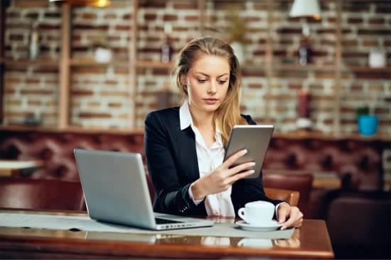 Woman reading a jewellery article on laptop